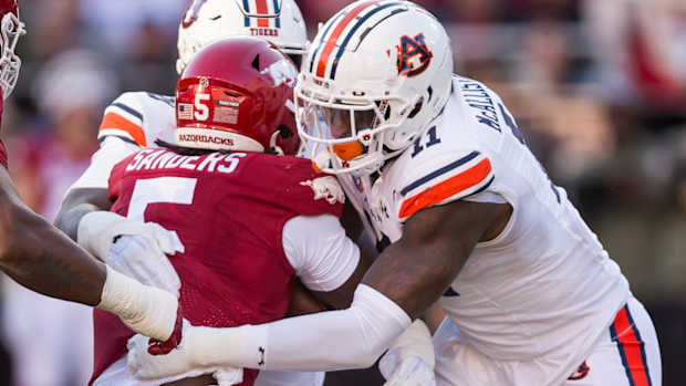 Razorbacks running back Raheim "Rocket" Sanders is tackled by Auburn's Elijah McAllister